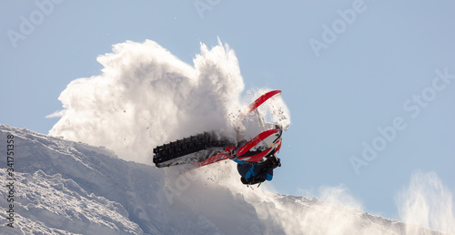 snowmobilers sports riding. Winter extreme ski-doo. an elite snowmobiler is testing a new model of mountain snowmobile, the prototype of 2021. bright snowmobile and suit. rider makes a turn and jump