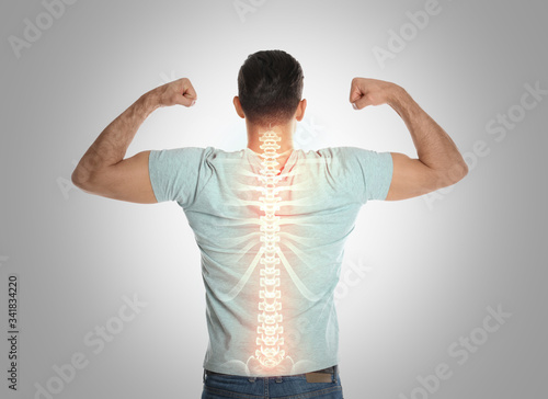 Man with healthy back on light background. Spine pain prevention