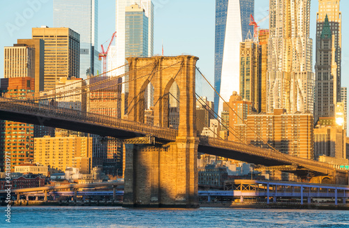 Famous Skyline of downtown New York, Brooklyn Bridge and Manhattan at the early morning sun light , New York City USA .