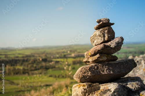 stack of stones with sky and montain background