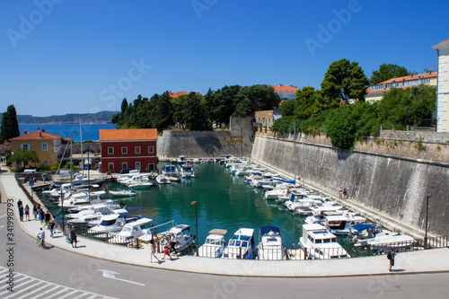 Zadar, Croatia; 07/17/2019: Lucica Fosa (Zadar harbour) full of boats and walls of the city in the old town of Zadar