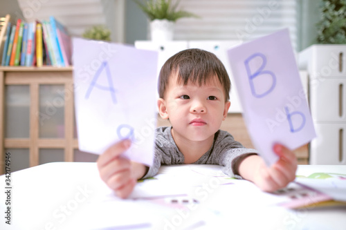 Kindergarten boy playing with flash cards , Asian children learning English with flash cards, Teach young kids English at home, Child at home, kindergarten closed during the Covid-19 health crisis