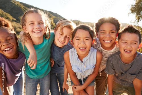 Portrait Of Multi-Cultural Children Hanging Out With Friends In Countryside Together