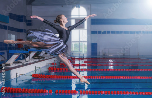 Ballerina jumps into the pool, slender professional dancer under the water and above the surface of the water, frozen movement dancing under the water in Pointe shoes