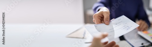 Businessperson Hands Giving Cheque