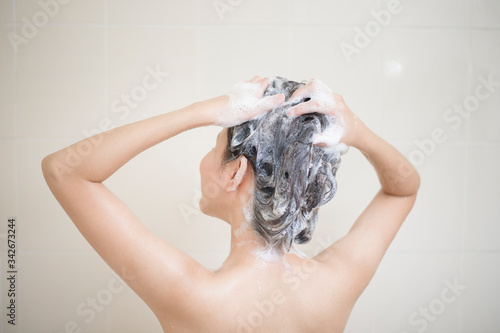 Happy beautiful woman is taking a shower