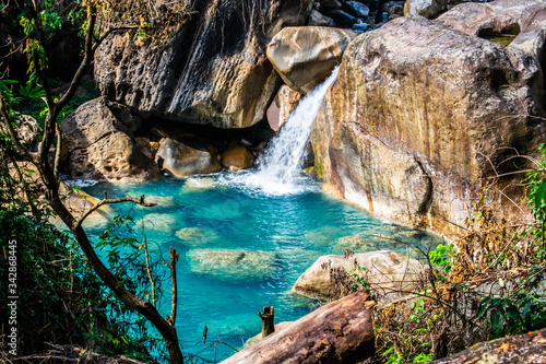 A crystal clear blue coloured natural swimming pool enroute Rainbow falls ahead Nongriat village in Cherrapunji. Found during winter trek to double decker living root bridge in Meghalaya, India.