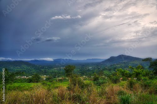 Clouds gather above the hills and rain forest of sub-saharan West Africa in the bush of Ghana.