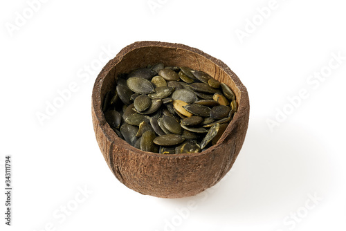 Pumpkin grains in small bowls with coconut on a white background