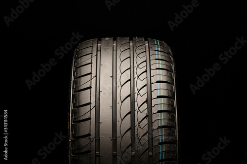 asymmetric summer tire. front view, close-up on a black background