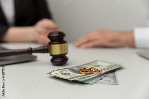 Legal alimony concept. Closeup view of wooden gavel and money