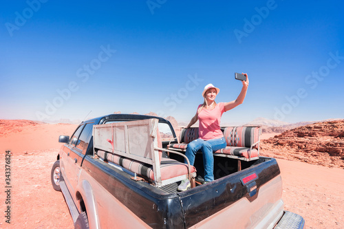 Tourist making selfie on safari in desert Wadi Rum, Jordan.