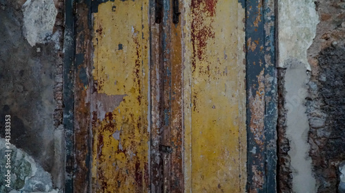 Iron fence ornaments and wooden doors in ancient Roman style buildings.