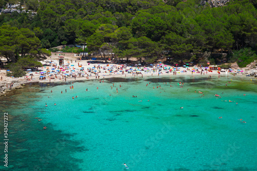 Bathers refresh themselves in the fresh and transparent waters of a bay on the island of Menorca in Spain.