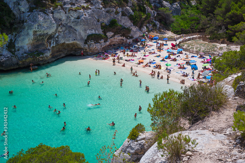 Bathers refresh themselves in the fresh and transparent waters of a bay on the island of Menorca in Spain.