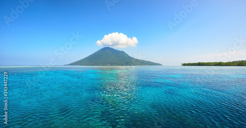 Beautiful panoramic view of volcanic island of Manado Tua on summer day. North Sulawesi, Indonesia