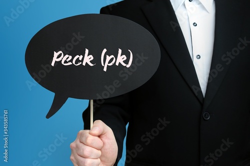 Peck (pk). Businessman in suit holds speech bubble at camera. The term Peck (pk) is in the sign. Symbol for business, finance, statistics, analysis, economy