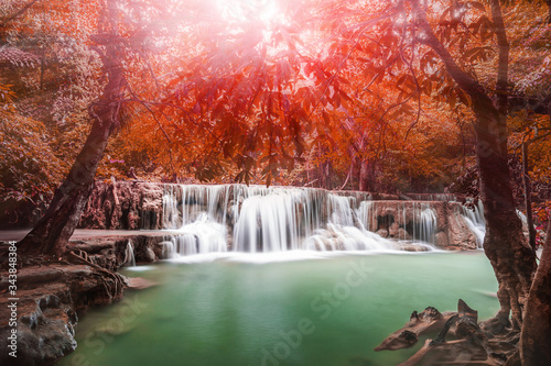 Waterfall in autumn forest with light ray tyndall lighting effect ,Huay Mae Kamin Waterfall , Beautiful waterfall in rainforest at Kanchanaburi province, Thailand