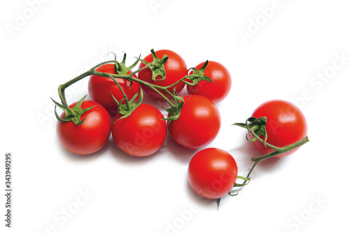 bunch of ripe cherry tomatoes on white background