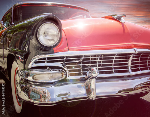 classic 1950s style car with sunset