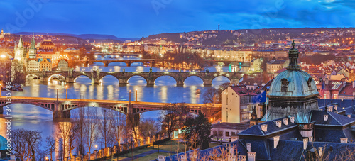 Prague capital city. Captivating night panorama of Prague's bridges in Czech Republic over Vltava river delta.