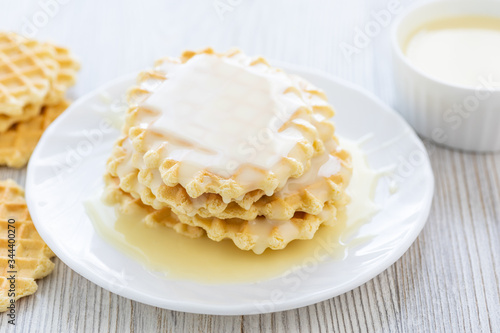 Sweet Condensed or evaporated milk and waffles on a table. A delicious Breakfast.