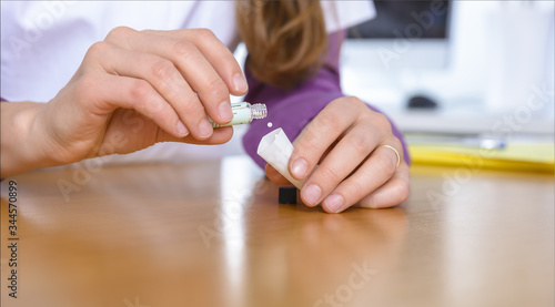 female doctor prepares homeopathic medicine - globules