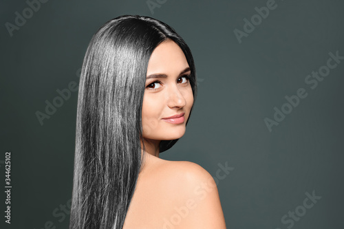 Portrait of beautiful model with grey hair on dark background