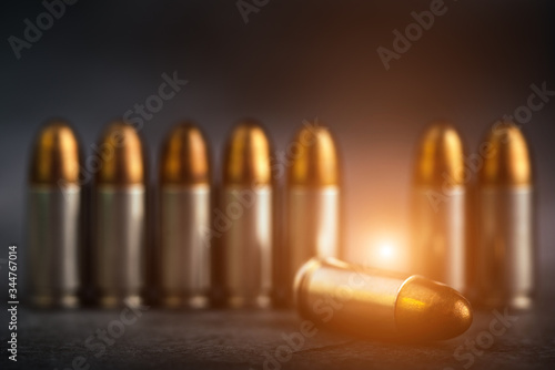 Bullet 9mm. On the dark stone table.rounds and military technology.