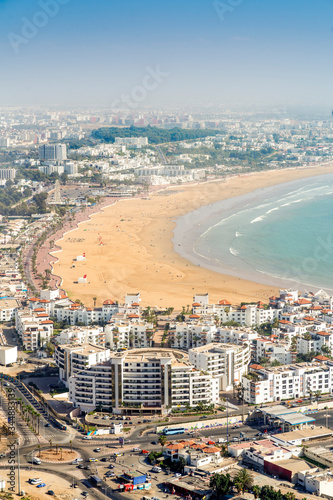 White modern architecture surrounding amazingly wide sandy beach in Agadir, Morocco