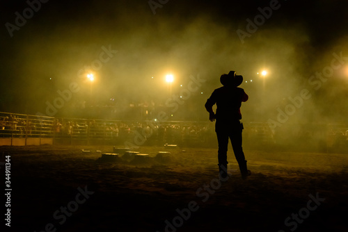 Rodeo workers from Brazil. Announcer calls to the crowd during rodeo show at an arena in Brazil.