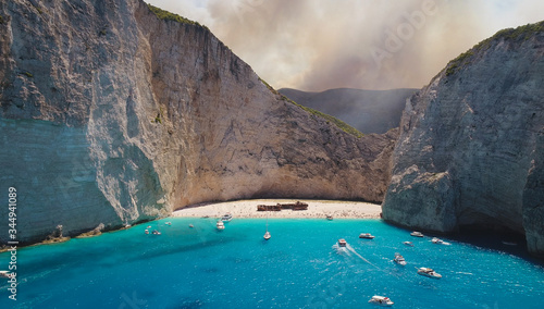 Zakynthos Navagio Shipwreck Bay in Greece, One Of the Most Unique Beaches on Earth, Wildfires Burning in the Background