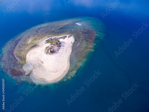 Aerial Isolated island with clear water and blue sky. Gili Kedis Lombok