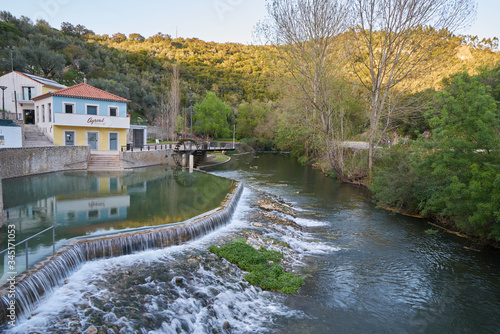 Agroal river fluvial beach with a waterfall and water mill in Portugal