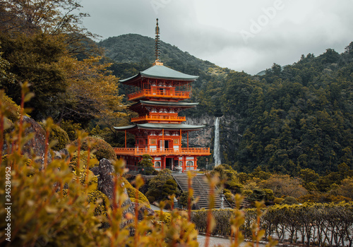 Mystical view over the ancient building and the huge waterfall at Kumano Nachi taisha, on the famous stone path Kumano Kodo pilgrimage route