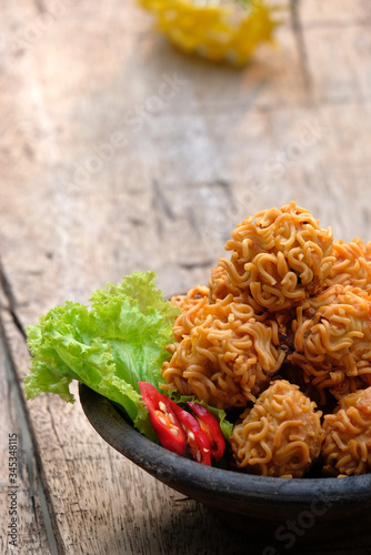 crispy noodle balls served on bowl, also known as bola bola mie