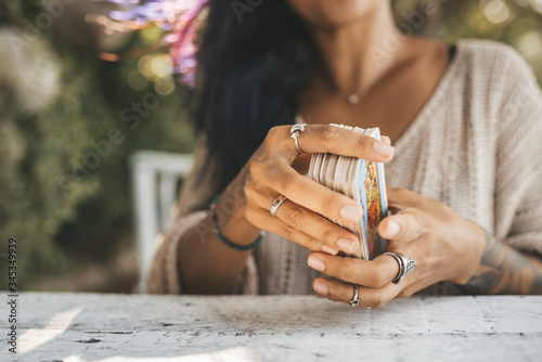 Close uo of female hands with Tarot cards