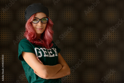 Geek girl with pink hair against abstract background