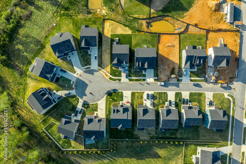 Aerial top down view of cul de sac dead end street with newly constructed single family homes and a home site for new construction at a new residential development in the East Coast USA 