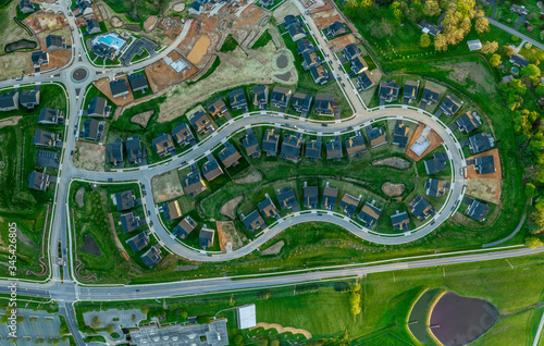 High resolution aerial view of a new residential real estate development with single family houses, home sites, community pool, curving streets in the East Coast USA