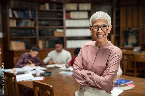 Smiling university professor in library