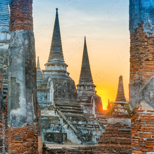 Brick ruins and three white stupas of ancient buddhist temple Wat Phra Si Sanphet. Historical architecture of Ayutthaya, Thailand