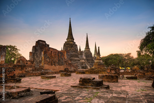 Brick ruins of ancient buddhist temple Wat Phra Si Sanphet at sunset. Architecture of Ayutthaya historical park, Thailand