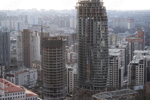 High-rise construction cranes on the background of houses on of the city of Kiev, Ukraine