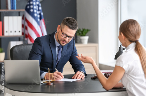 Male judge working with client in office