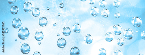 Water bubbles on blue water background, abstract fresh sparkling water banner, fizzing air sparkles