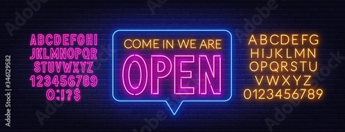 Come in we are open neon sign. Neon alphabet on brick wall background. Vector illustration.