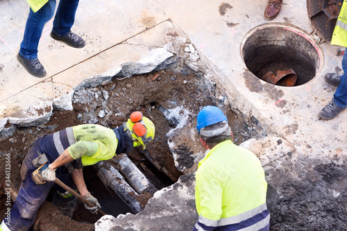 sewer utility worker for cleaning and repairing sewerage pipes in construction site