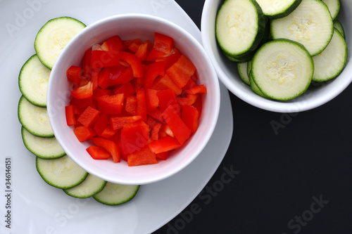 Carved couchette and paprika in a white bowl and on a white plate. Copy space for text.