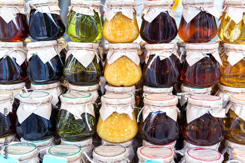Various types of natural delicious jam in glass jars.